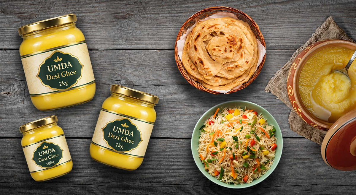 Three jars of UMDA Desi Ghee in different sizes arranged on a dark wooden table, alongside prepared food including a plate of flatbread, a bowl of mixed vegetable salad, and another bowl of ghee with a spoon.